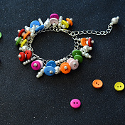Armband mit 2-Loch-Knopfperlen und Perlenanhängern